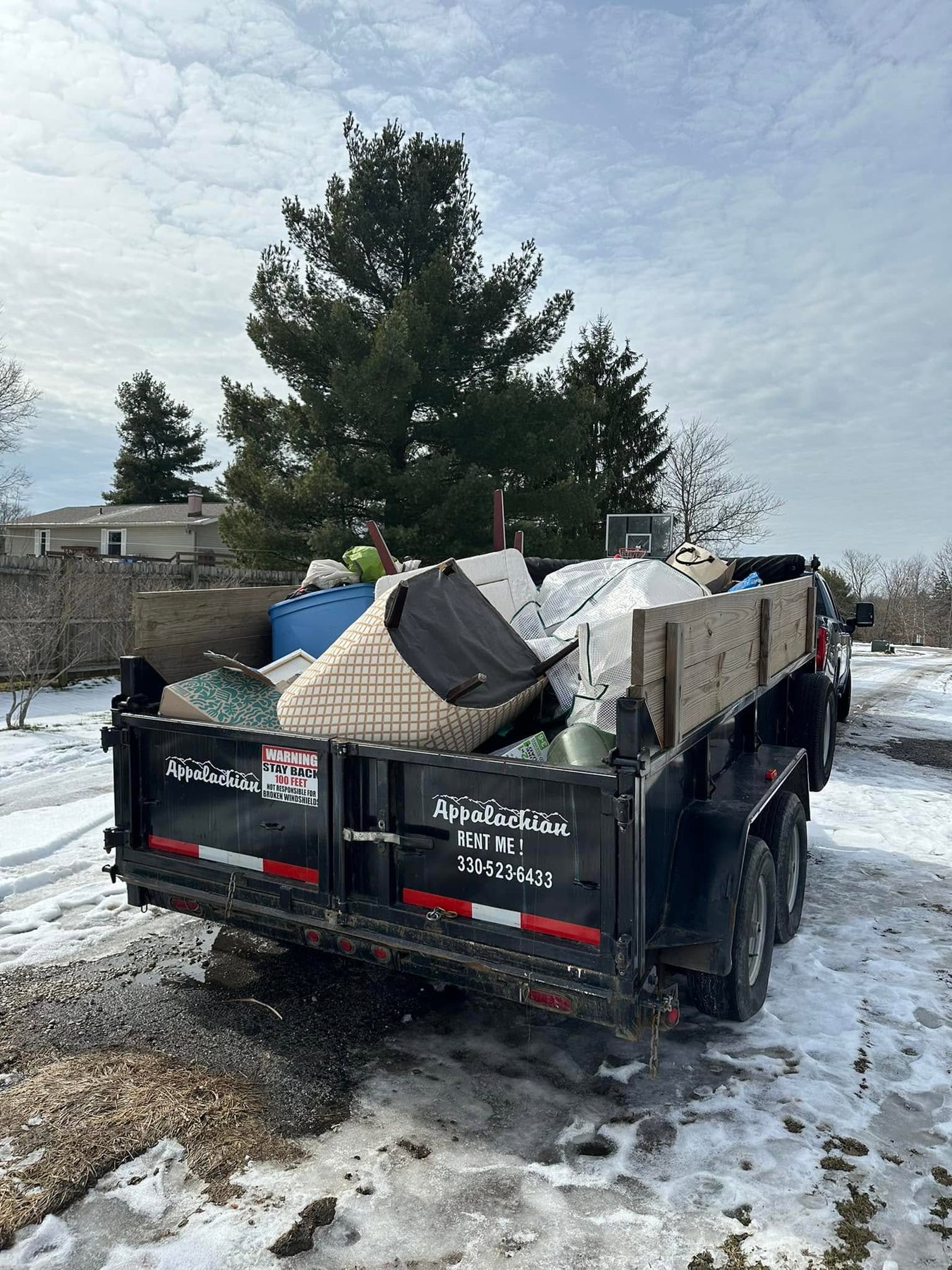 Dump trailer loaded during a house cleanout