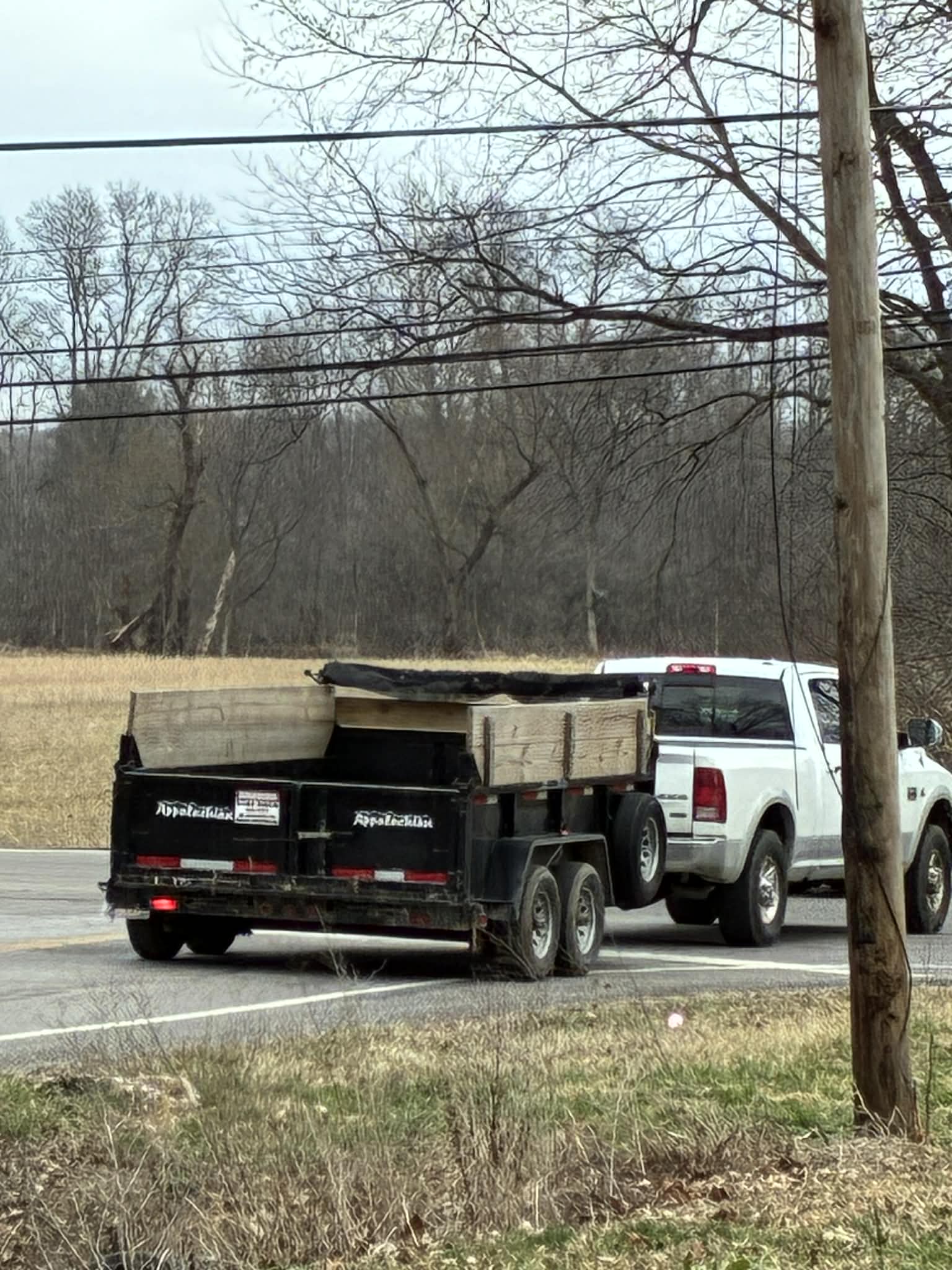 Pickup truck hauling a loaded dump trailer