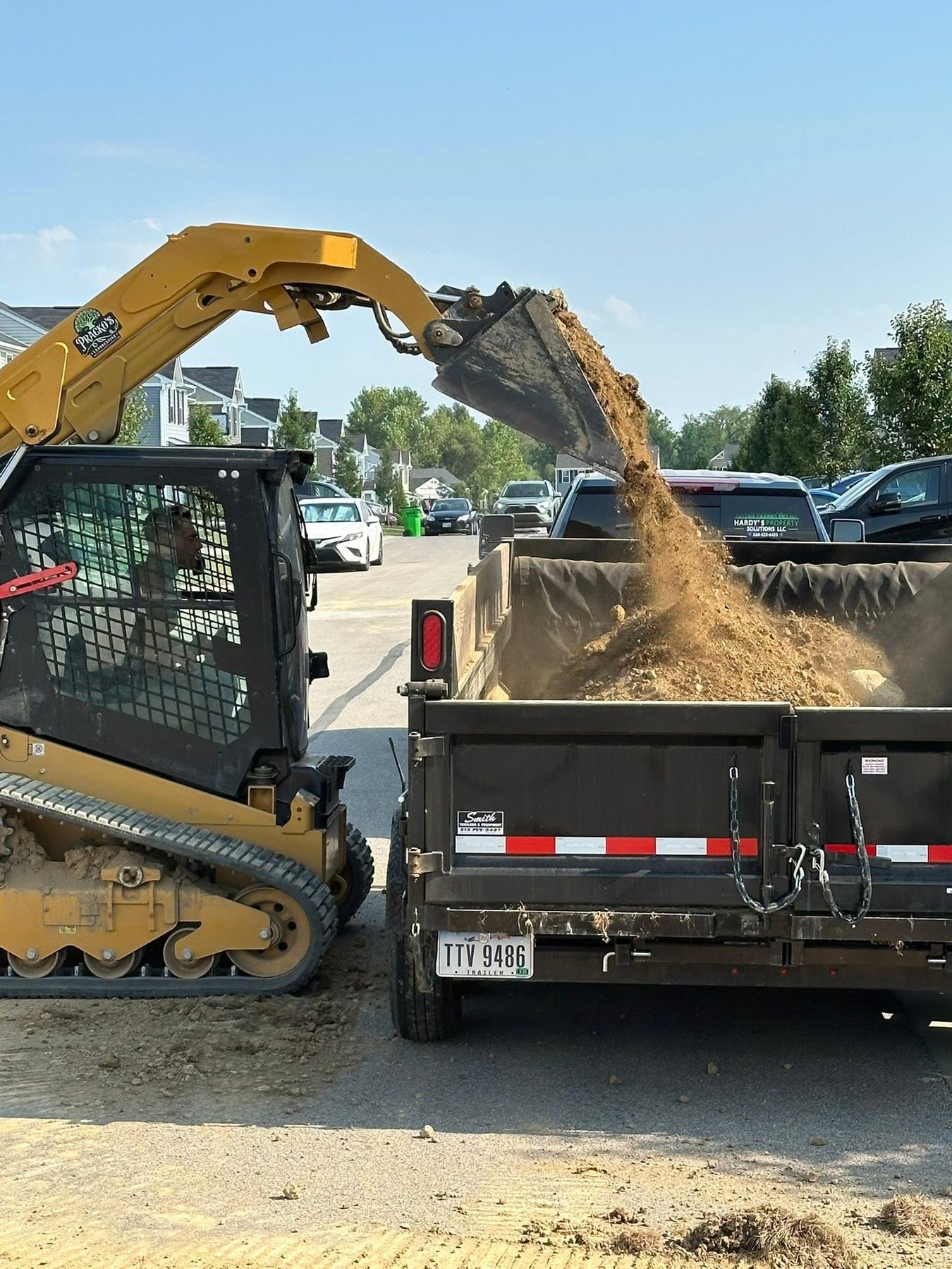 Equipment loading material into a dump trailer